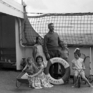 Maureen, Keiran, Margie, Kate and Colleen with Dad on board ship going to Wellington, NZ