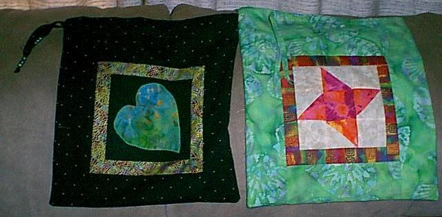 I started with a block, the heart is appliqued, the star is a pieced Friendship Star. Then I framed the blocks, then pieced in the background fabric. These bags are like envelopes with a drawstring at top. 