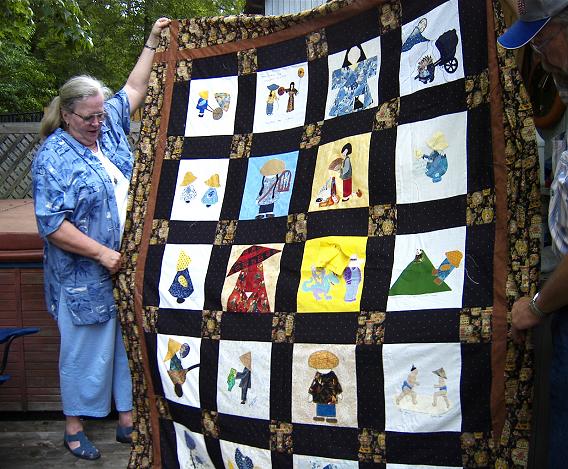 Twenty one Birthday Blocks  were made for me by quilting friends . Instead of choosing a pieced block, I asked they design a block for a quilt named "Sunbonet Sue Visits the Orient"  Two of the blocks came from Australia. I put the blocks together. Fabric in the cornerstones, fussy cut Oriental Ginger Jars, is also the backing of this quilt.  