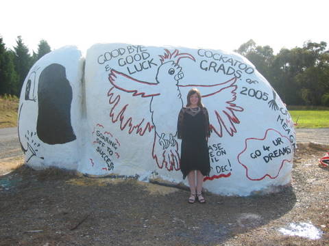 This is my daughter Hannah on the occasion of her primary school graduation. The parent club paint this rock, known as Elephant Rock, every year in celebration. The other side has all their names on it.