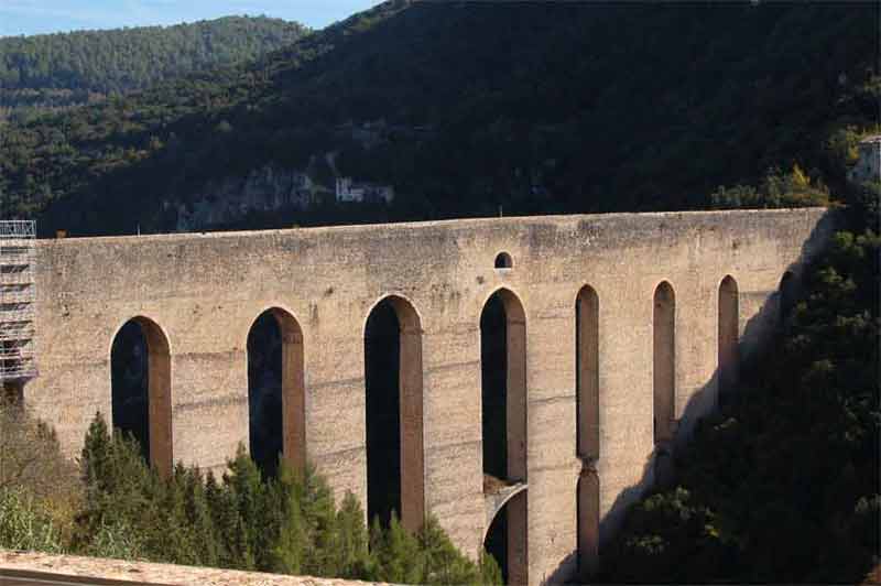 Italy - remains of old roman aqueduct within a newer bridge