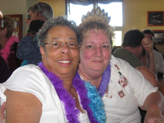 Just gussied up with boas and tiaras...waiting at the bar for our table.