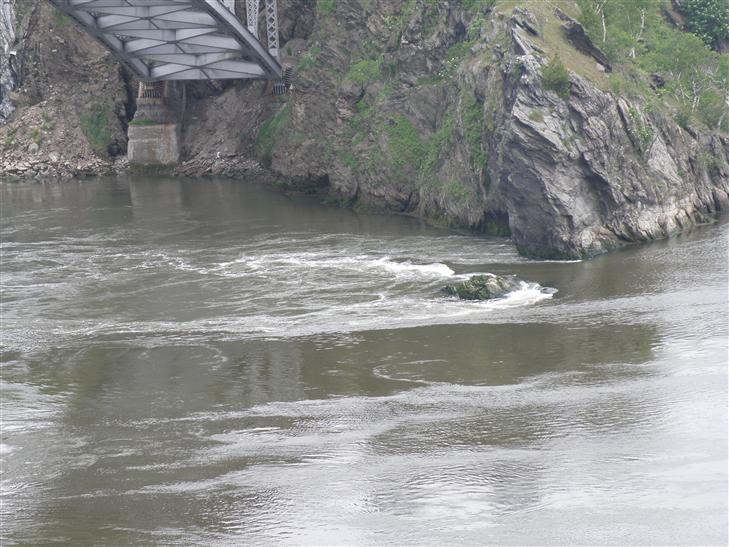 at the mouth of the Saint John River, when the rapids flow backwards as the Bay of Fundy flows upriver, creating the Reversing Falls effect.