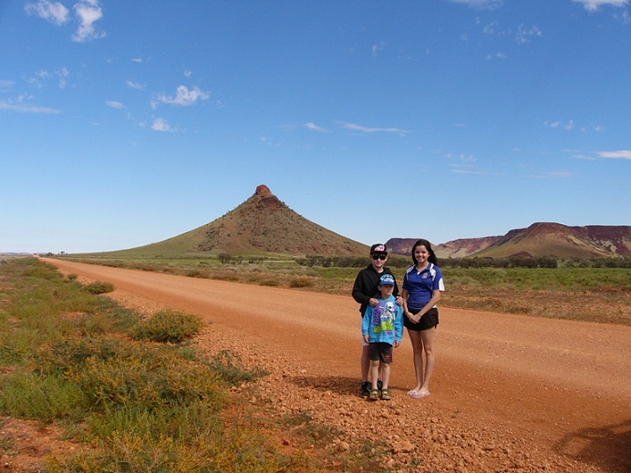 Johnathan, Hayley and Bailey with "Pyramid Hill" in the Pilbara in the background.