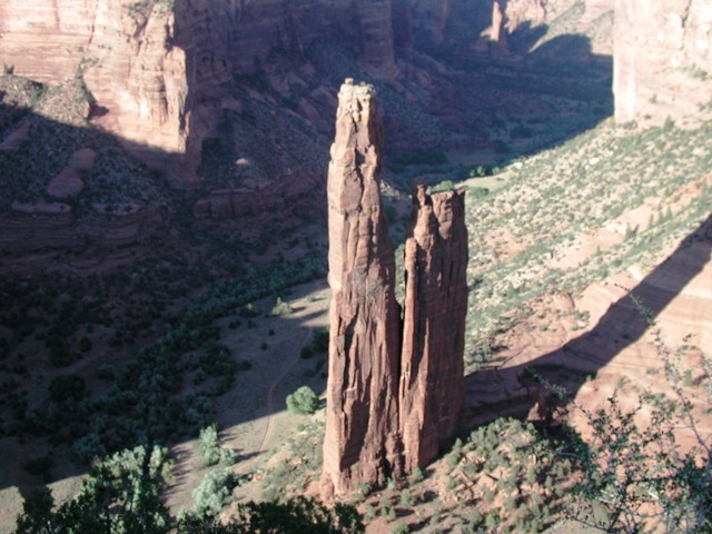 Canyon de Chelly is both a national monument and home to the Navajo Indians.  This photo was taken from the top of the canyon looking 800 feet down. The Indians have a legend about these tall "spider rocks" that gave them their name, but I cannot recall the legend anymore. Our Navajo tour guide told us that in his youth they actually climbed up and down these steep canyon walls to visit friends on the other side. His uncle still has his summer home in the bottom of the canyon.