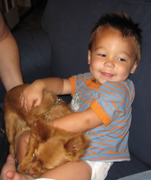 Brandon happily greeted his dog, a long hair chihuahua, Milo.  The dog must have been just as happy (ran up to him licking his face)!