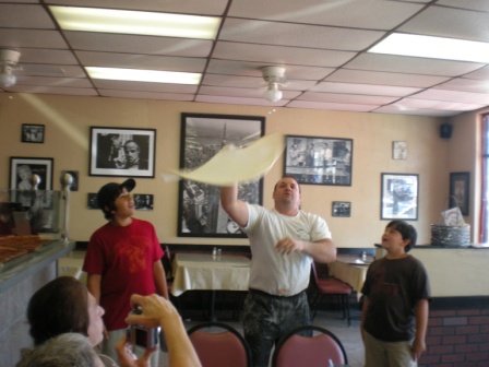 Lenny tossing our pizza, Tami's sons Mitchell on the left & Dylan on the right