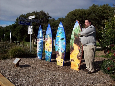 Keith choosing his surfboard. I was a bit concerned that he was not looking at the sign which shows the way to the beach.