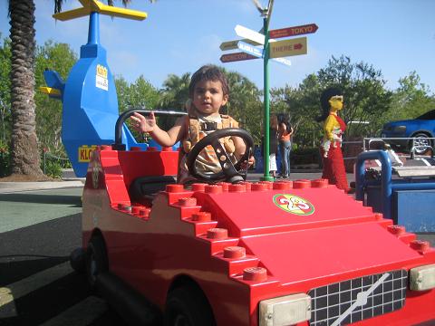 Kevin makes a hand sign to turn right while he drives his car.