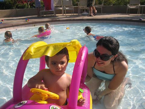 Kevin drive his small water car in the swimming pool.