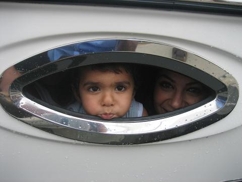 Kevin have a look yhrough boat small window,in New Port beach, Boat tour.